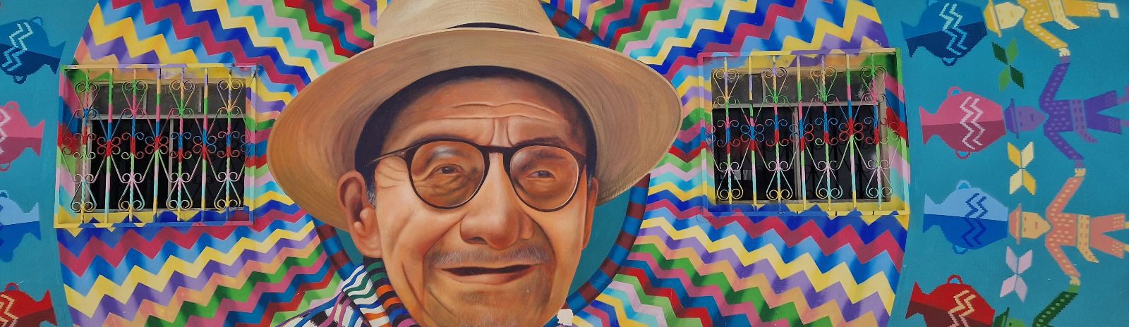 Rondreis Guatemala, Late Atitlán, San Juan, kleurrijke streetart op de muur