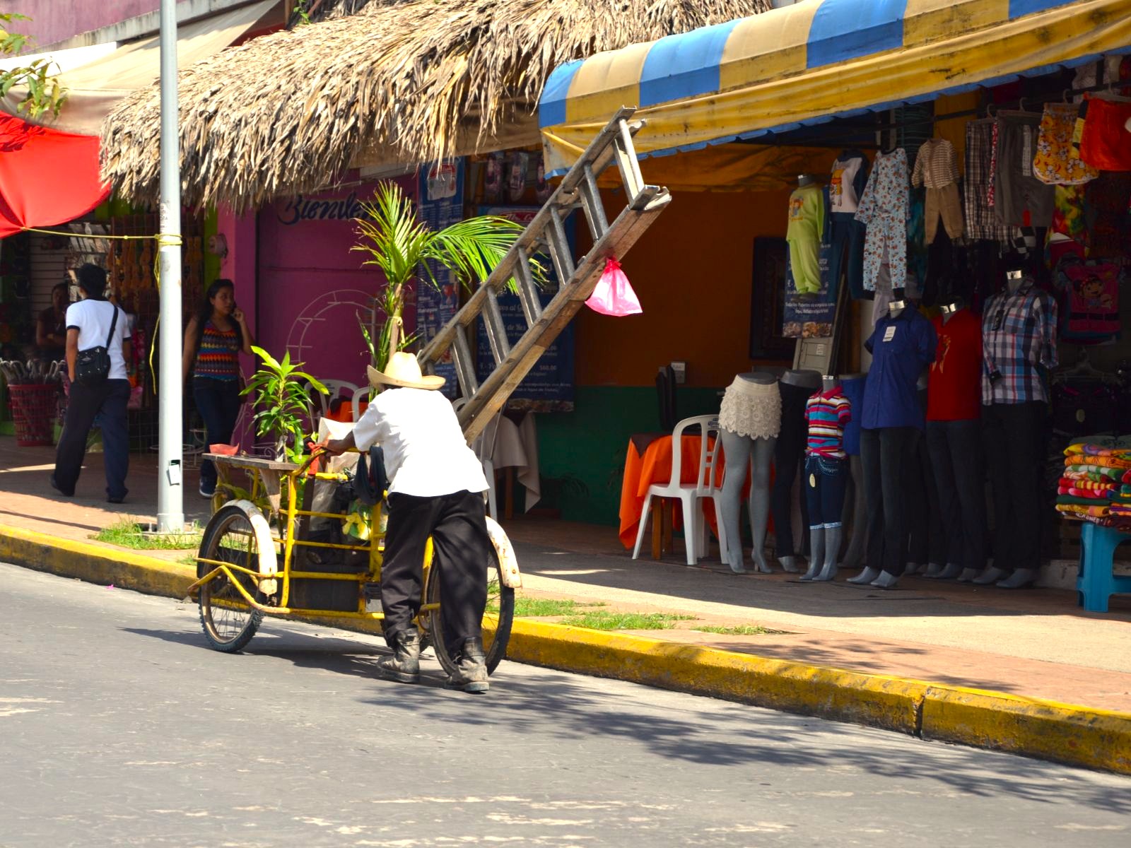Rondreis Mexico, Palenque, man lopend met fiets op straat