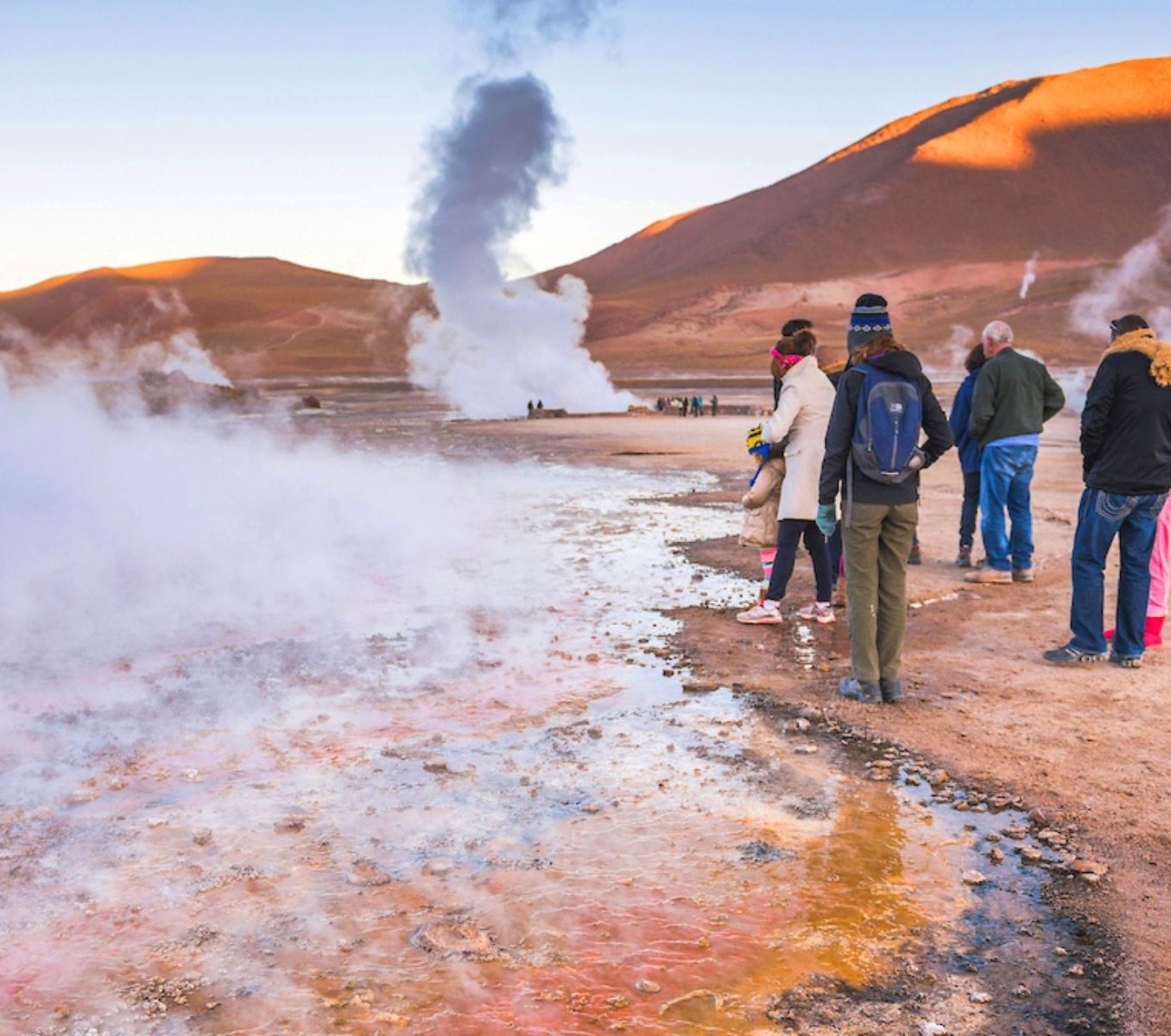 Rondreis Chili, San Pedro de Atacama, excursie stoom en zonsopgang bij Tatio geisers, mensen naast de roze geiser