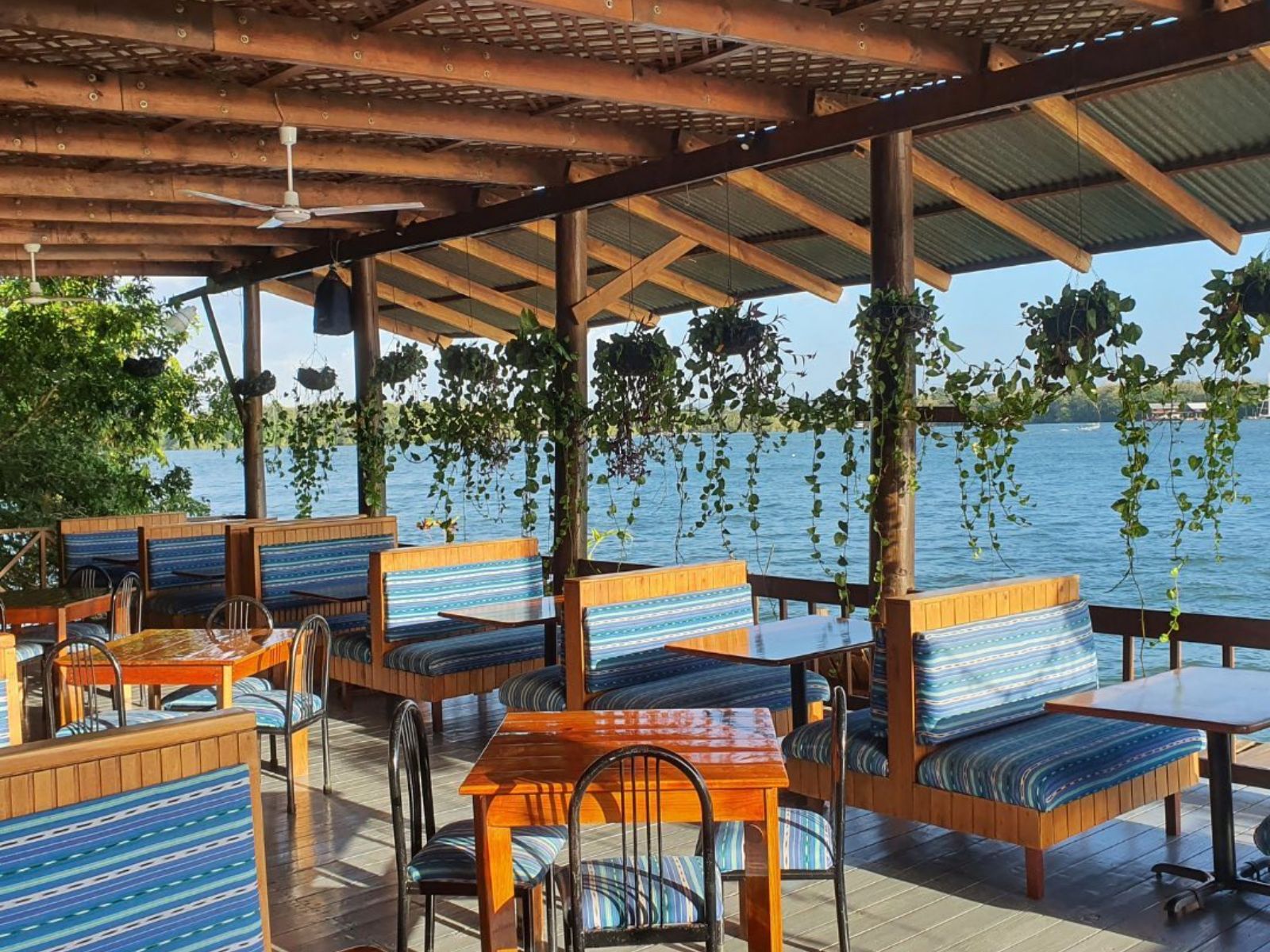 Rondreis Guatemala, Rio Dulce, Hotel Catamaran, terras aan het water met zitgedeelte