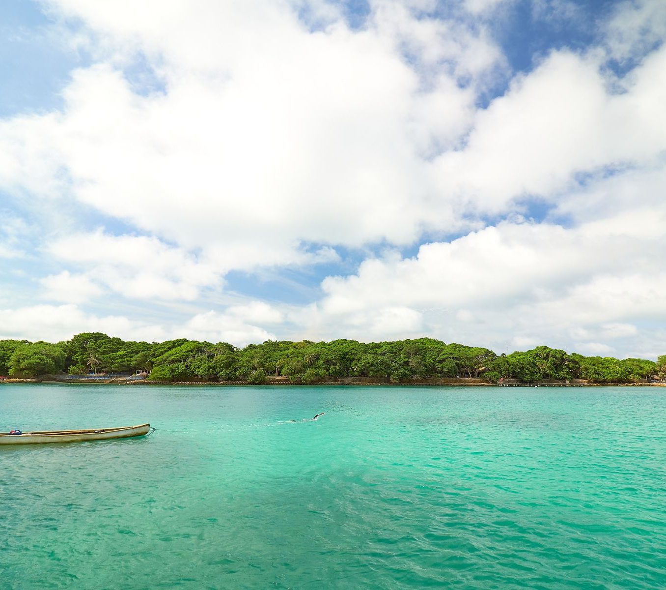 Rondreis Colombia, Cartagena, excursie dagtour naar tropisch Isla Majagua, zee en kust met blauwe lucht en wolken