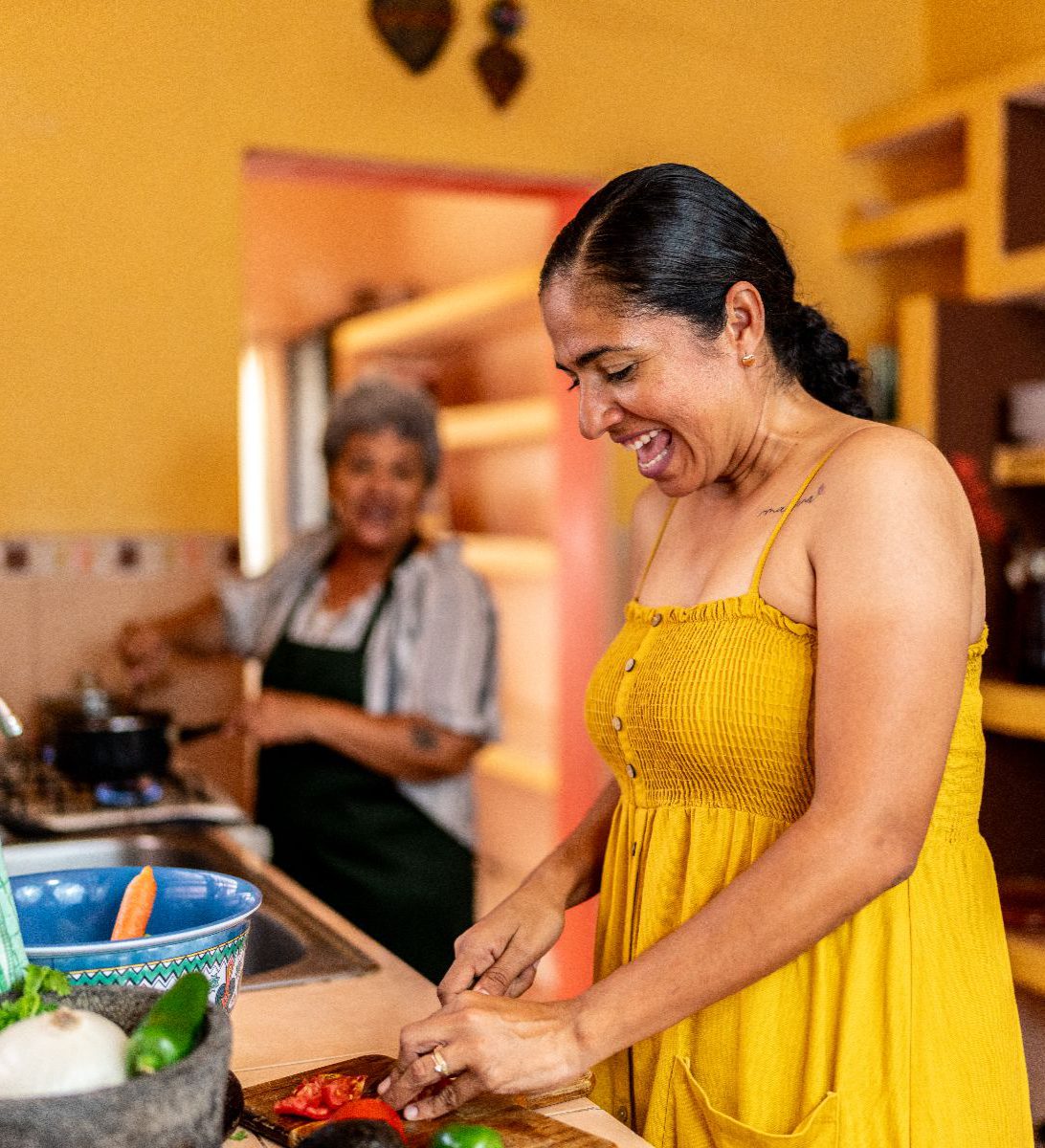 Rondreis Mexico, Merida-Oaxaca, Koken bij de locals in Merida, in de keuken bij locals, vrouw die groenten snijd