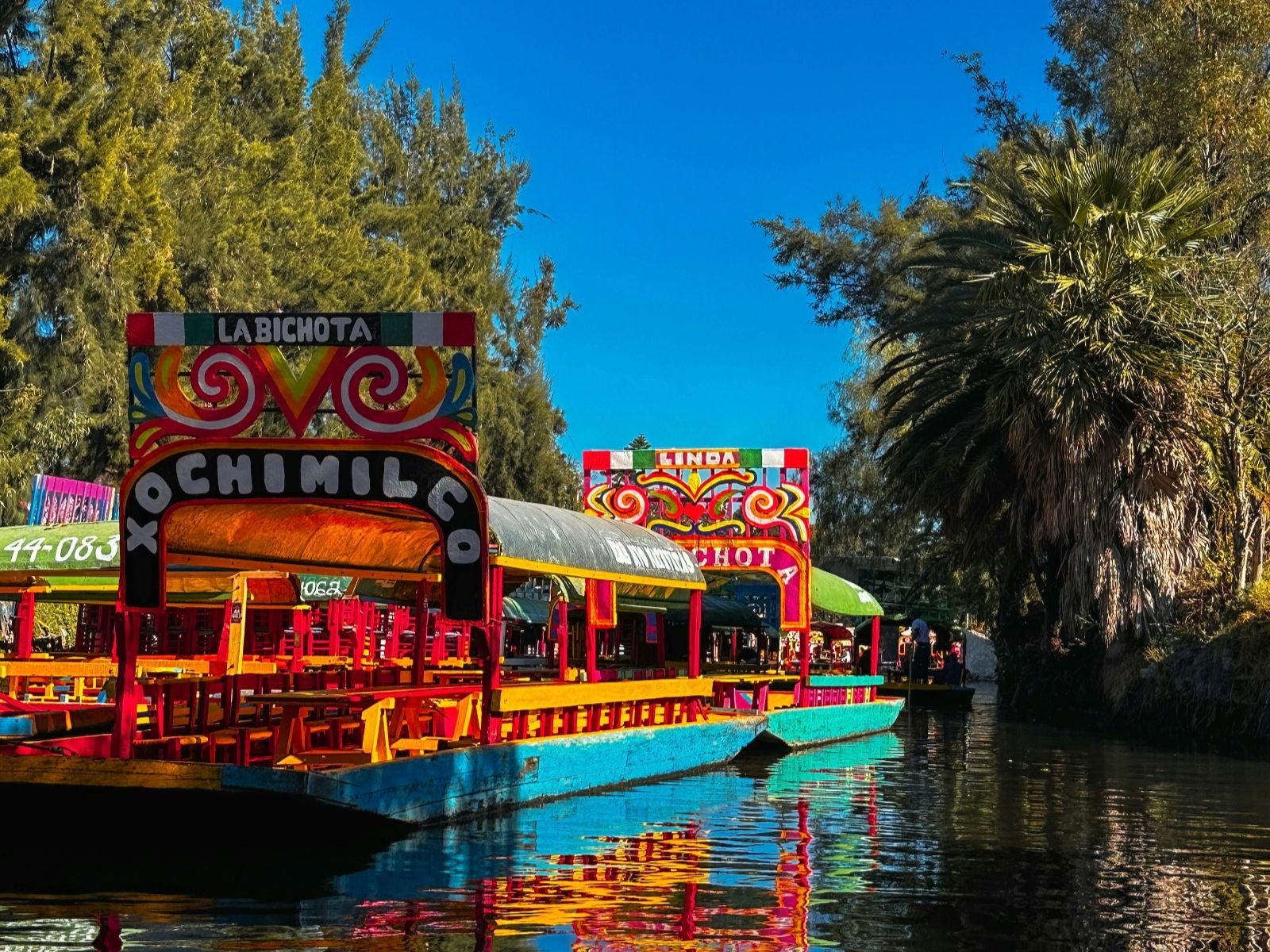 Rondreis Mexico, Mexico-Stad, Varen tussen kleuren en tradities in Xochimilco, mooie versierde boot op het water